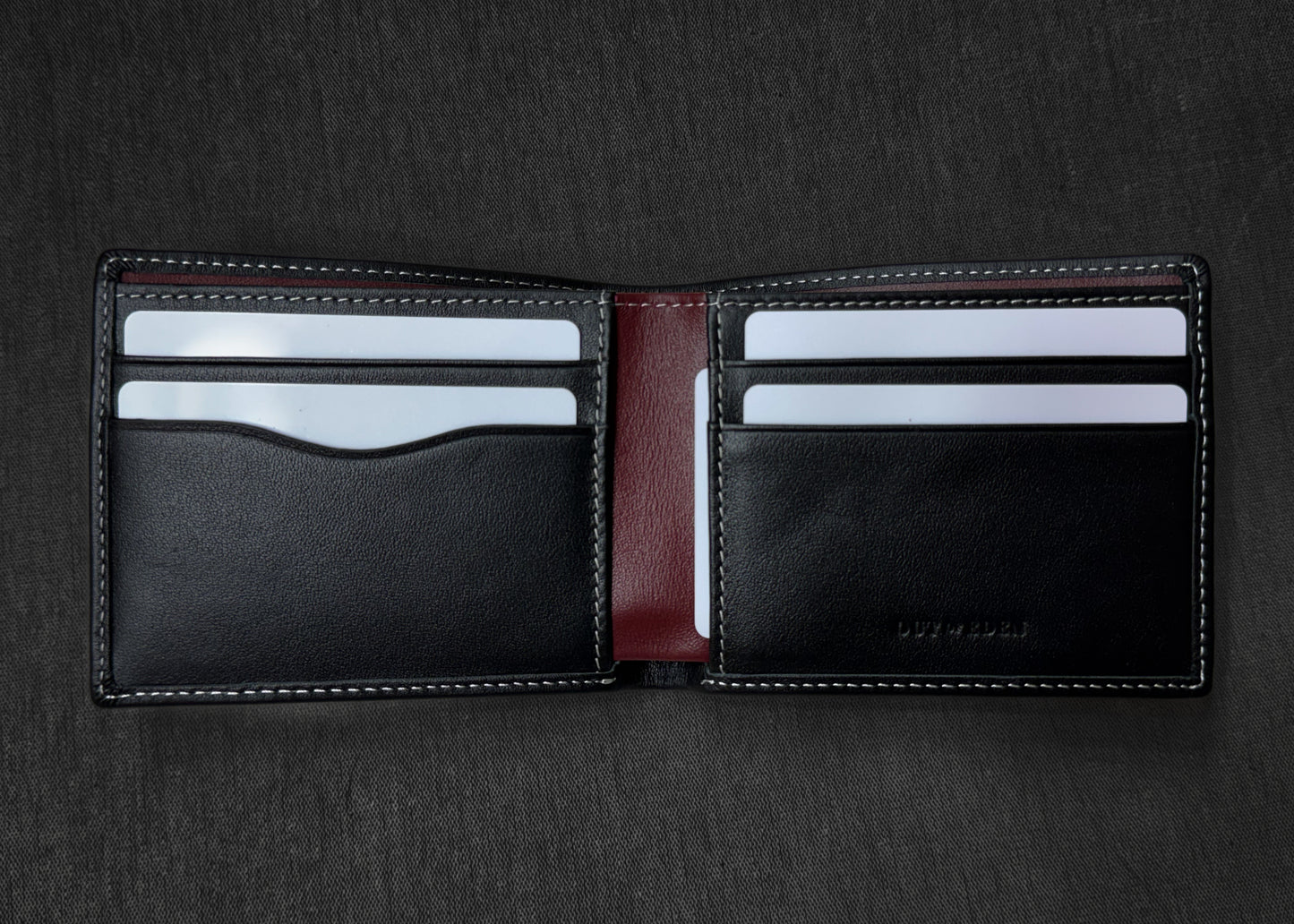 Black leather wallet with card slots on a dark background