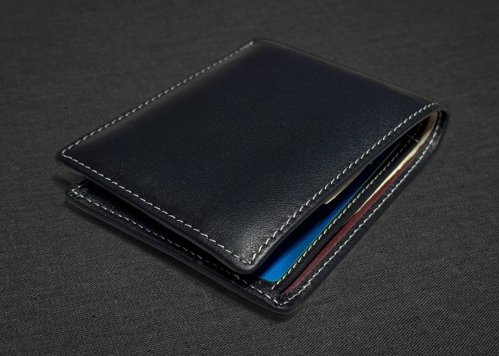 Black leather wallet on a dark gray background