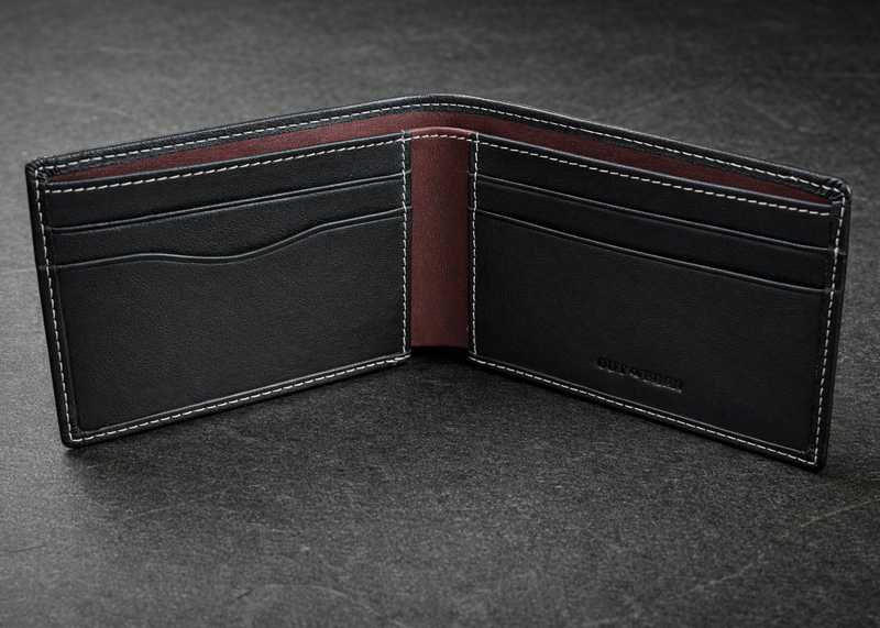 Black leather wallet with red interior on a dark gray background