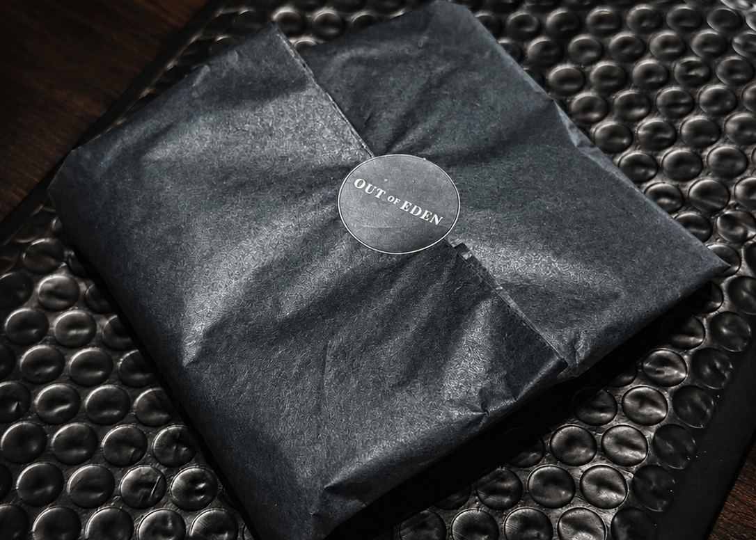 Black folded fabric with a brand label on a textured surface
